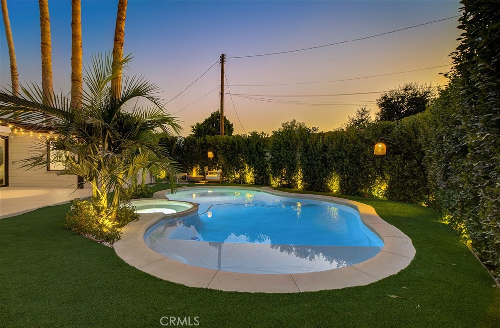 8161 Encino Avenue Northridge, CA 91325 - Photo 15 of 72 a view of a swimming pool with a yard and plants