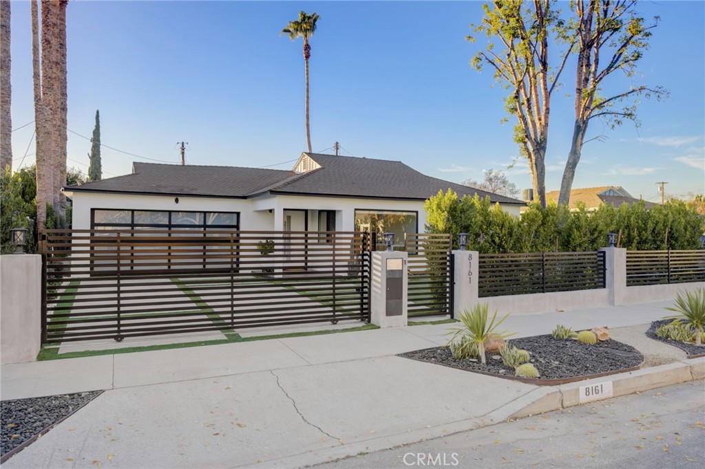 8161 Encino Avenue Northridge, CA 91325 - Photo 20 of 72 a front view of a house with a garden