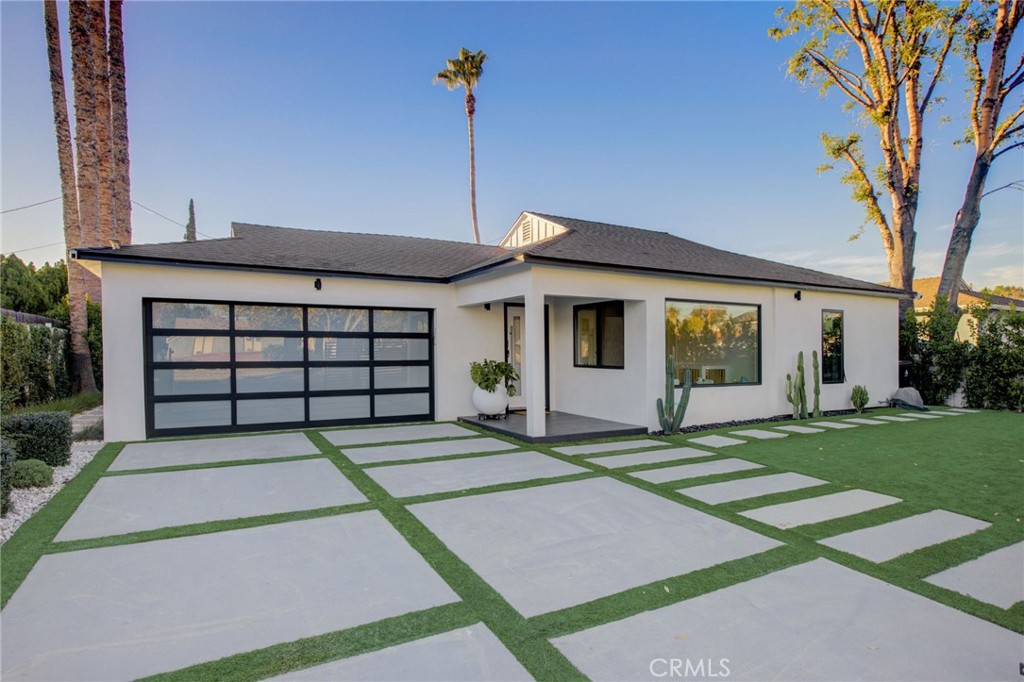 8161 Encino Avenue Northridge, CA 91325 - Photo 23 of 72 a front view of a house with a yard