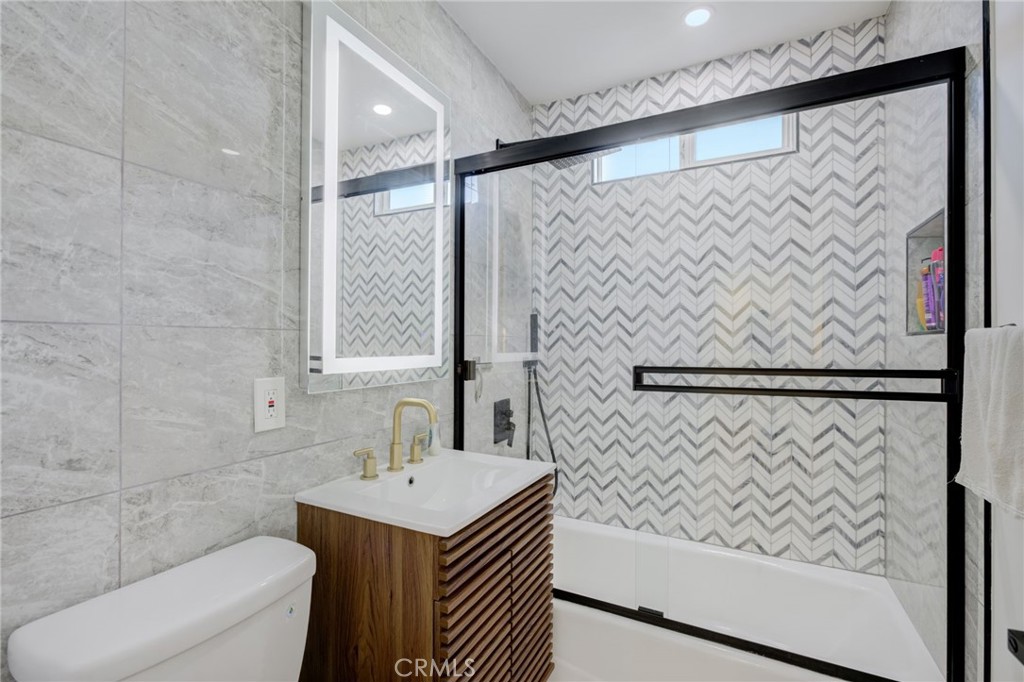 8161 Encino Avenue Northridge, CA 91325 - Photo 38 of 72 a bathroom with a sink and a mirror