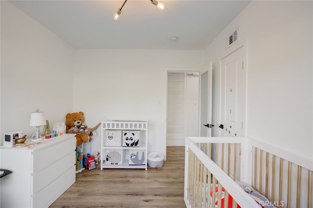 8161 Encino Avenue Northridge, CA 91325 - Photo 40 of 72 a view of a bedroom with baby crib and lounge chair