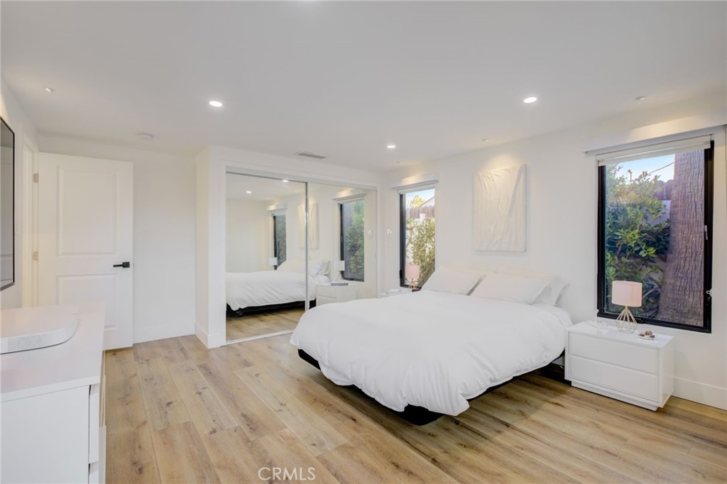8161 Encino Avenue Northridge, CA 91325 - Photo 43 of 72 a large bedroom with a bed and wooden floor