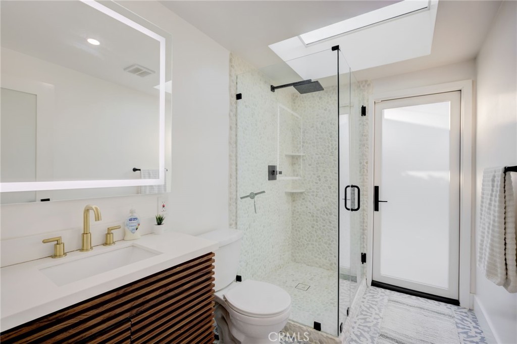 8161 Encino Avenue Northridge, CA 91325 - Photo 45 of 72 a bathroom with a sink toilet vanity and shower