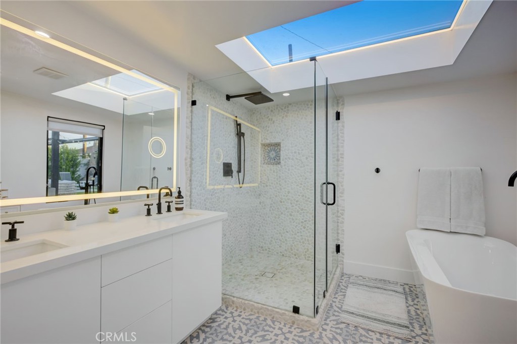 8161 Encino Avenue Northridge, CA 91325 - Photo 50 of 72 a bathroom with a shower sink and mirror