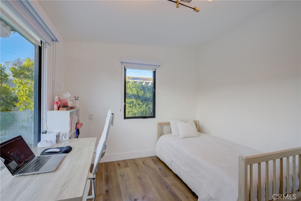 8161 Encino Avenue Northridge, CA 91325 - Photo 51 of 72 a bedroom with furniture and a window