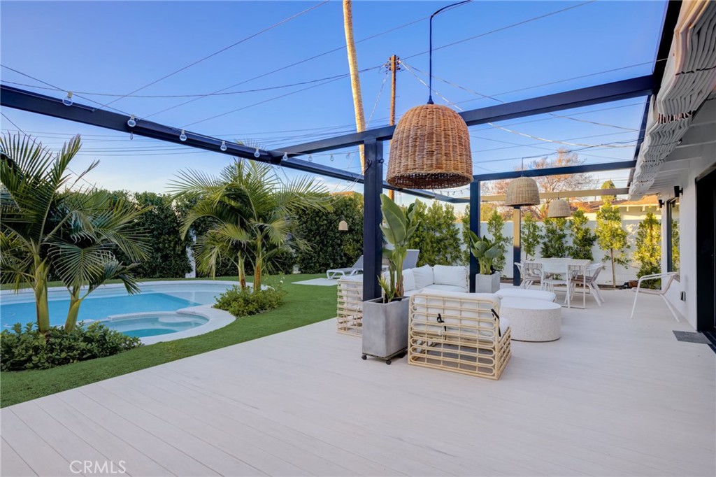 8161 Encino Avenue Northridge, CA 91325 - Photo 55 of 72 a view of a patio with couches and a table and chairs under an umbrella