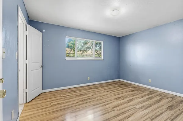 a view of room with wooden floor and window