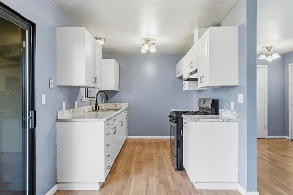a kitchen with stainless steel appliances a sink stove and refrigerator