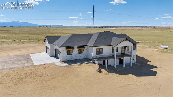 a aerial view of a house with swimming pool and mountain view