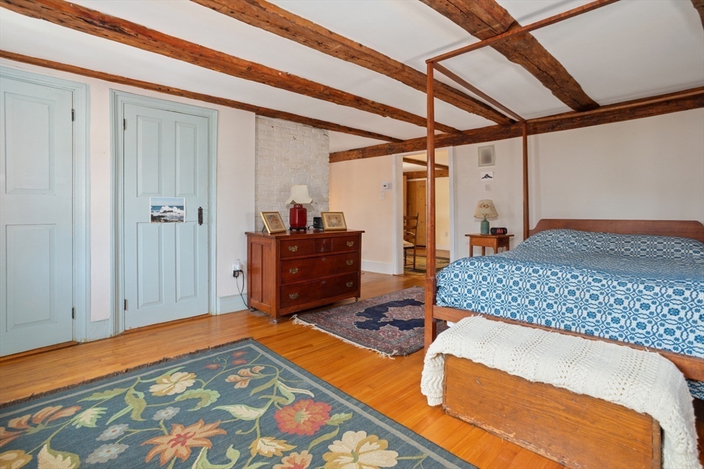16 Pine Street Gloucester, MA 01930 - Photo 22 of 42 a bedroom with a bed and a dresser