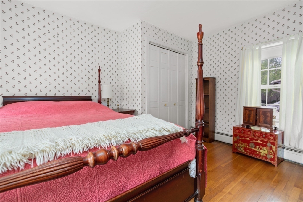 16 Pine Street Gloucester, MA 01930 - Photo 28 of 42 a bedroom with a bed and wooden floor