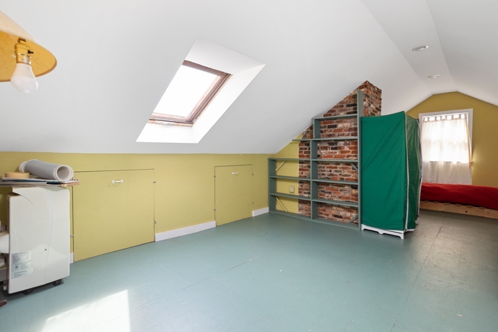 16 Pine Street Gloucester, MA 01930 - Photo 33 of 42 a view of an empty room with a window and a bedroom