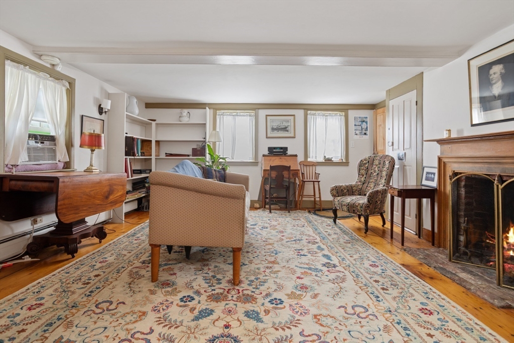 16 Pine Street Gloucester, MA 01930 - Photo 6 of 42 a living room with furniture a fireplace and a table