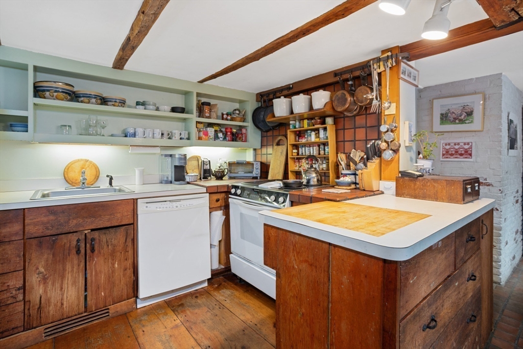 16 Pine Street Gloucester, MA 01930 - Photo 10 of 42 a kitchen with a stove a sink and a refrigerator