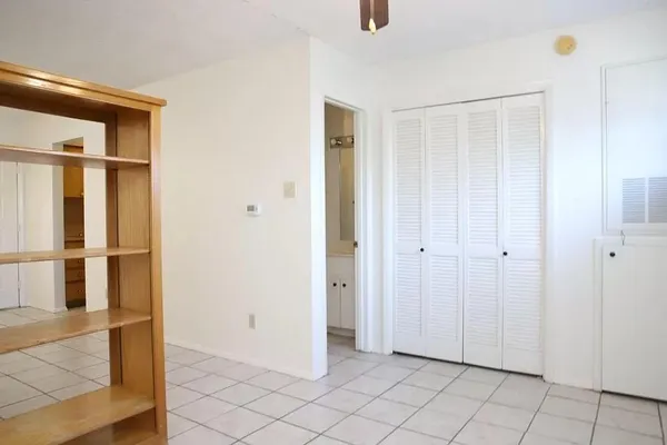 a view of an empty room with wooden door