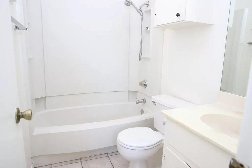 4701 Red River Street, Unit 302 Austin, TX 78751 - Photo 6 of 7 a bathroom with a sink a toilet and a bathtub