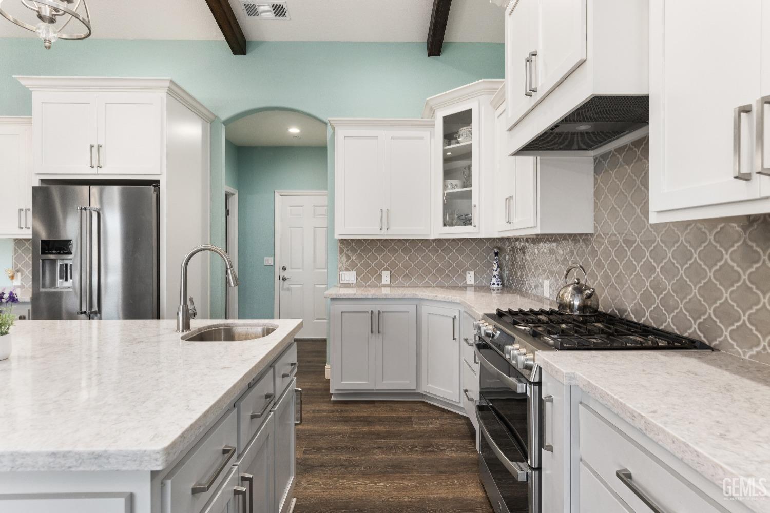 Undisclosed Address Tehachapi, CA 93561 - Photo 16 of 43 a kitchen with stainless steel appliances granite countertop a sink stove and cabinets
