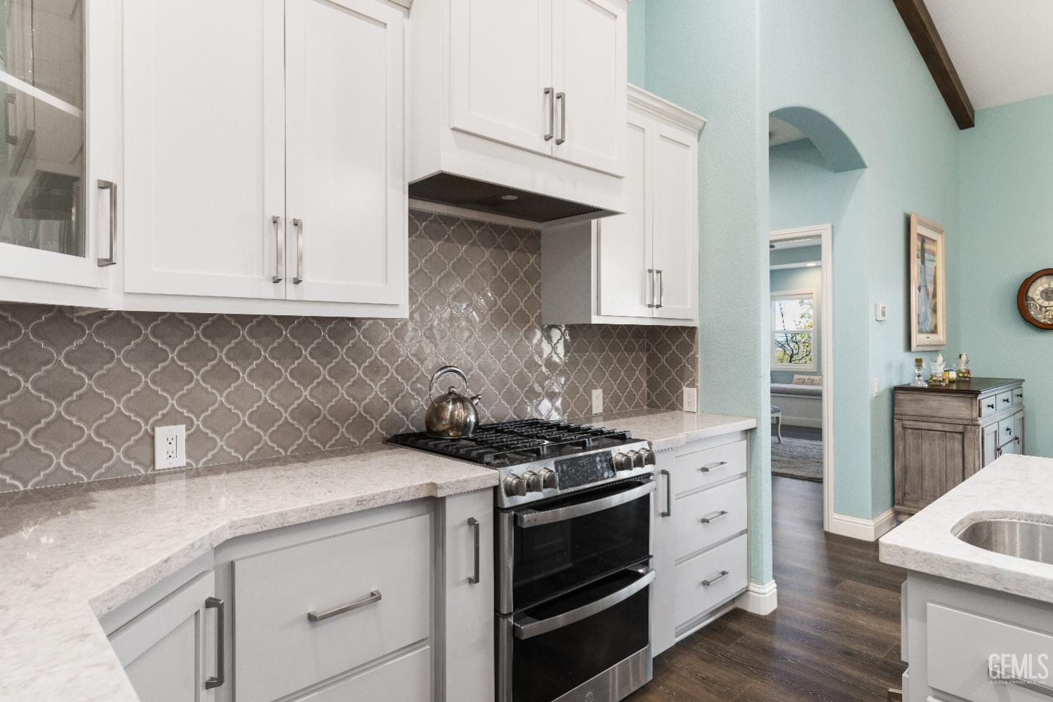 Undisclosed Address Tehachapi, CA 93561 - Photo 17 of 43 a kitchen with granite countertop white cabinets and stainless steel appliances
