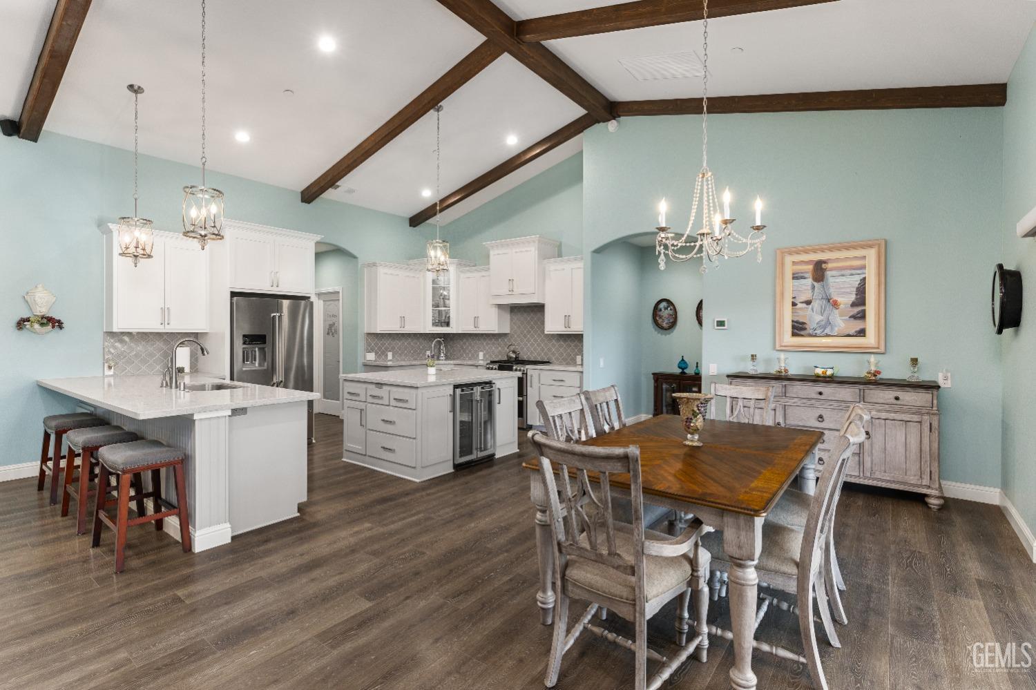 Undisclosed Address Tehachapi, CA 93561 - Photo 20 of 43 a kitchen with a dining table chairs stainless steel appliances and cabinets