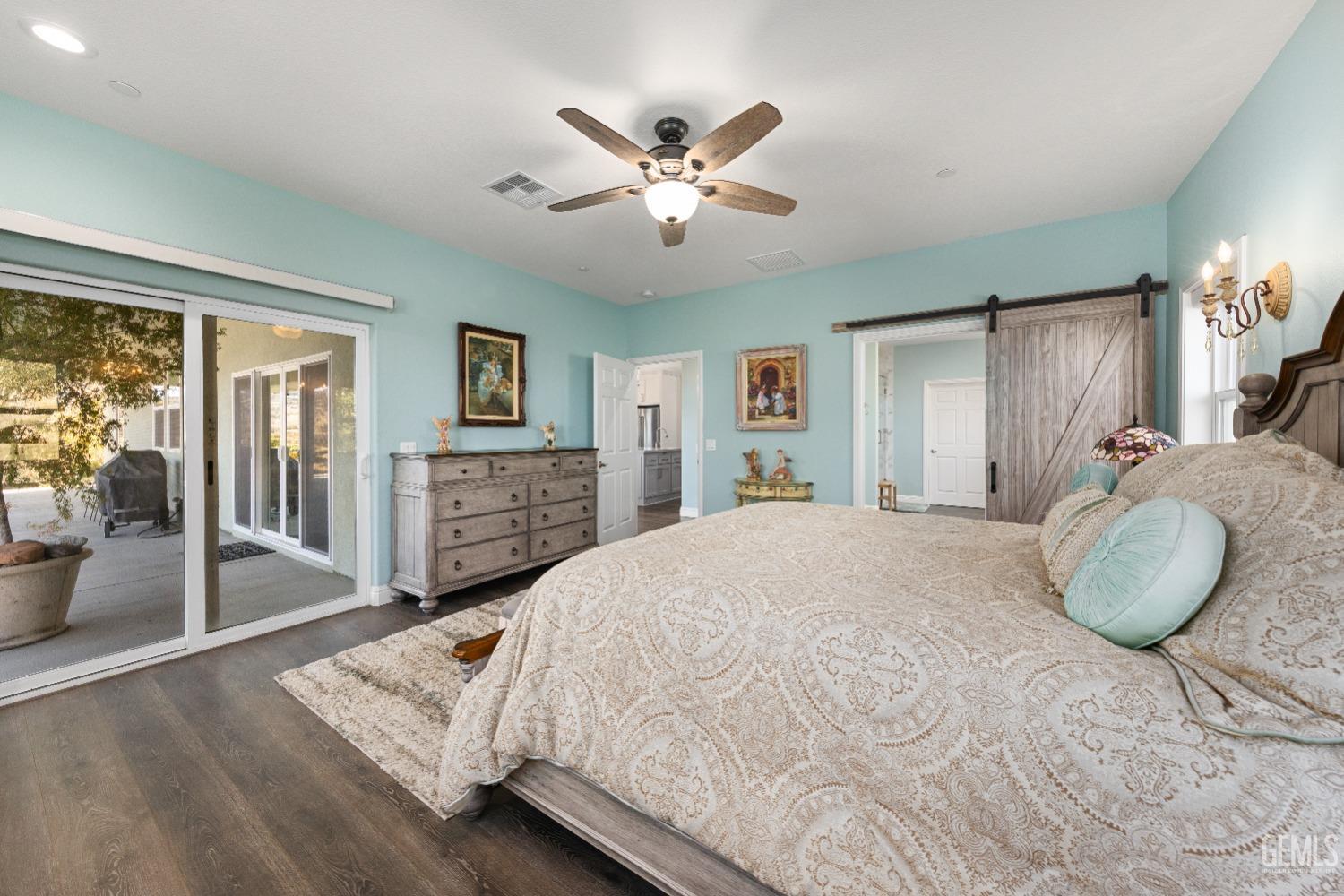 Undisclosed Address Tehachapi, CA 93561 - Photo 24 of 43 a spacious bedroom with a large bed a chandelier and dresser