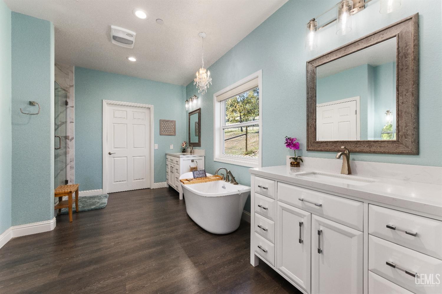 Undisclosed Address Tehachapi, CA 93561 - Photo 26 of 43 a living room with white cabinets and a wooden floor