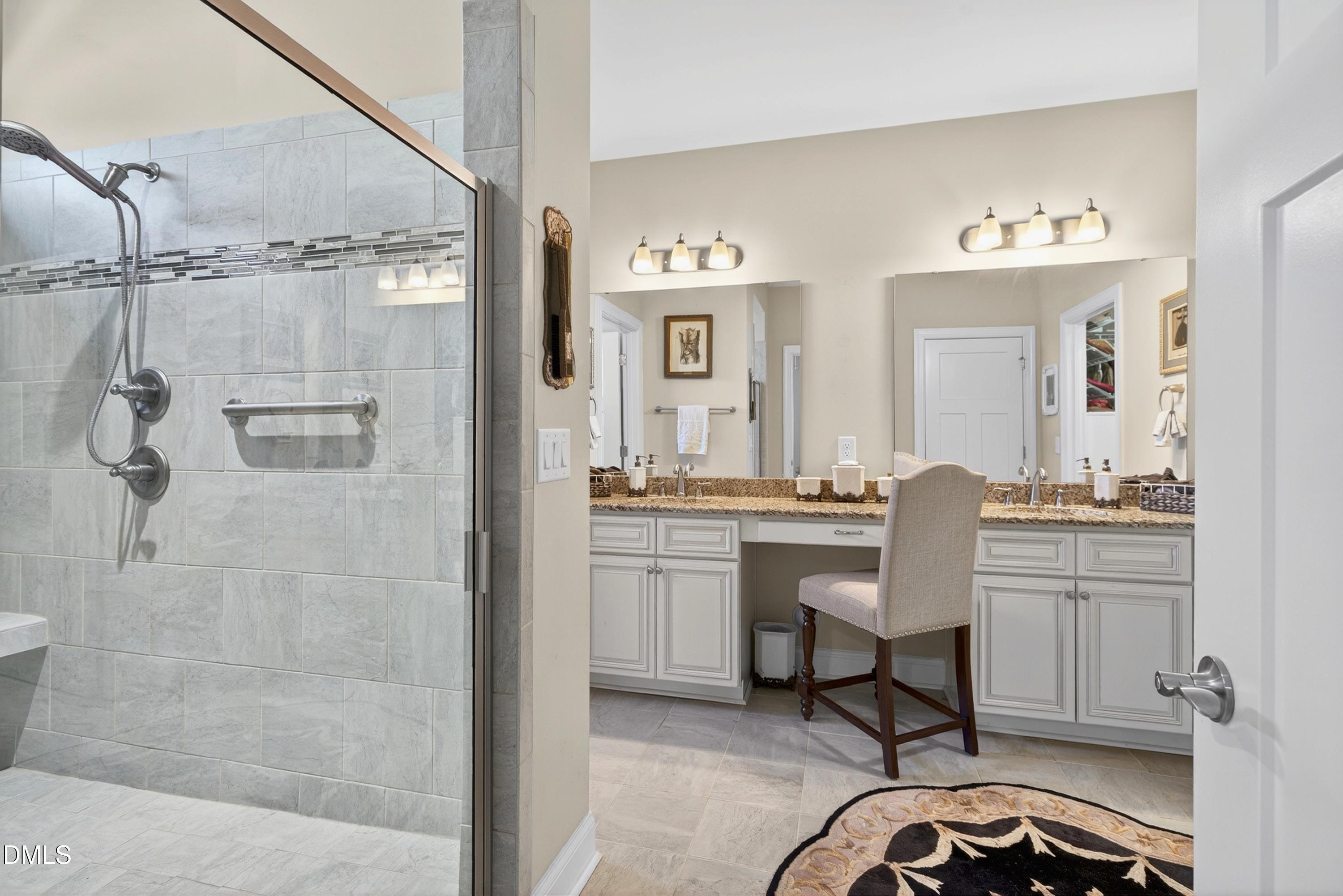 121 Telluride Trail Garner, NC 27529 - Photo 12 of 41 a bathroom with a granite countertop sink a mirror and a shower