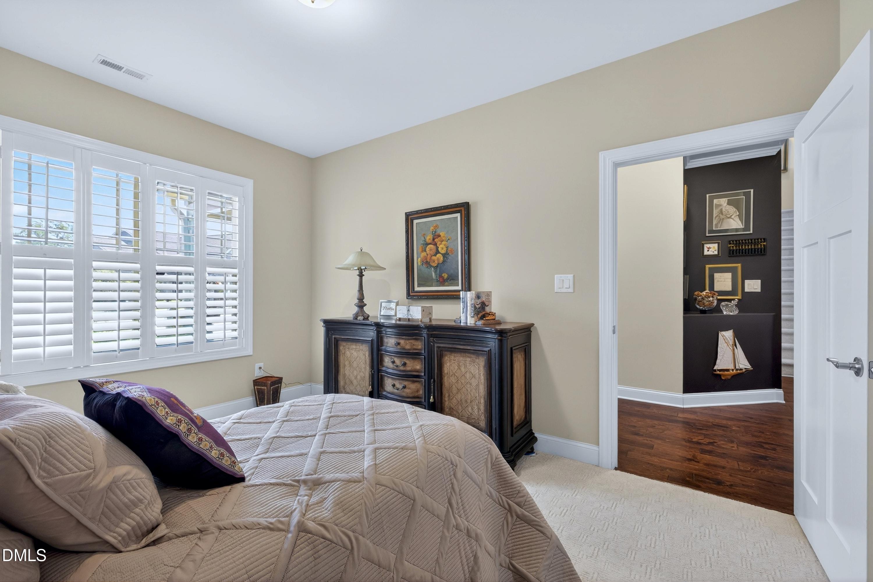 121 Telluride Trail Garner, NC 27529 - Photo 17 of 41 a bedroom with a bed and dresser with mirror