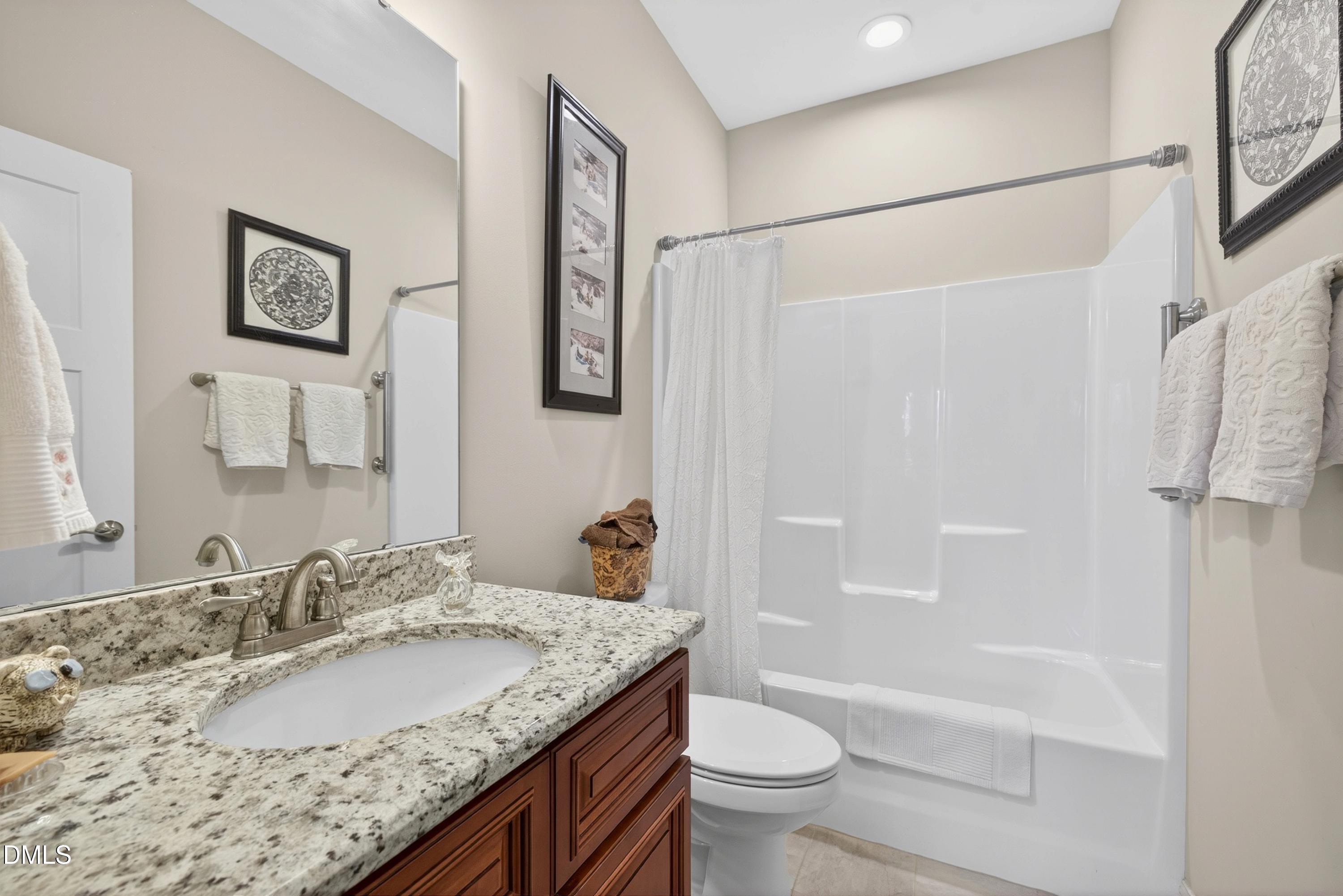 121 Telluride Trail Garner, NC 27529 - Photo 18 of 41 a bathroom with a granite countertop sink toilet and shower