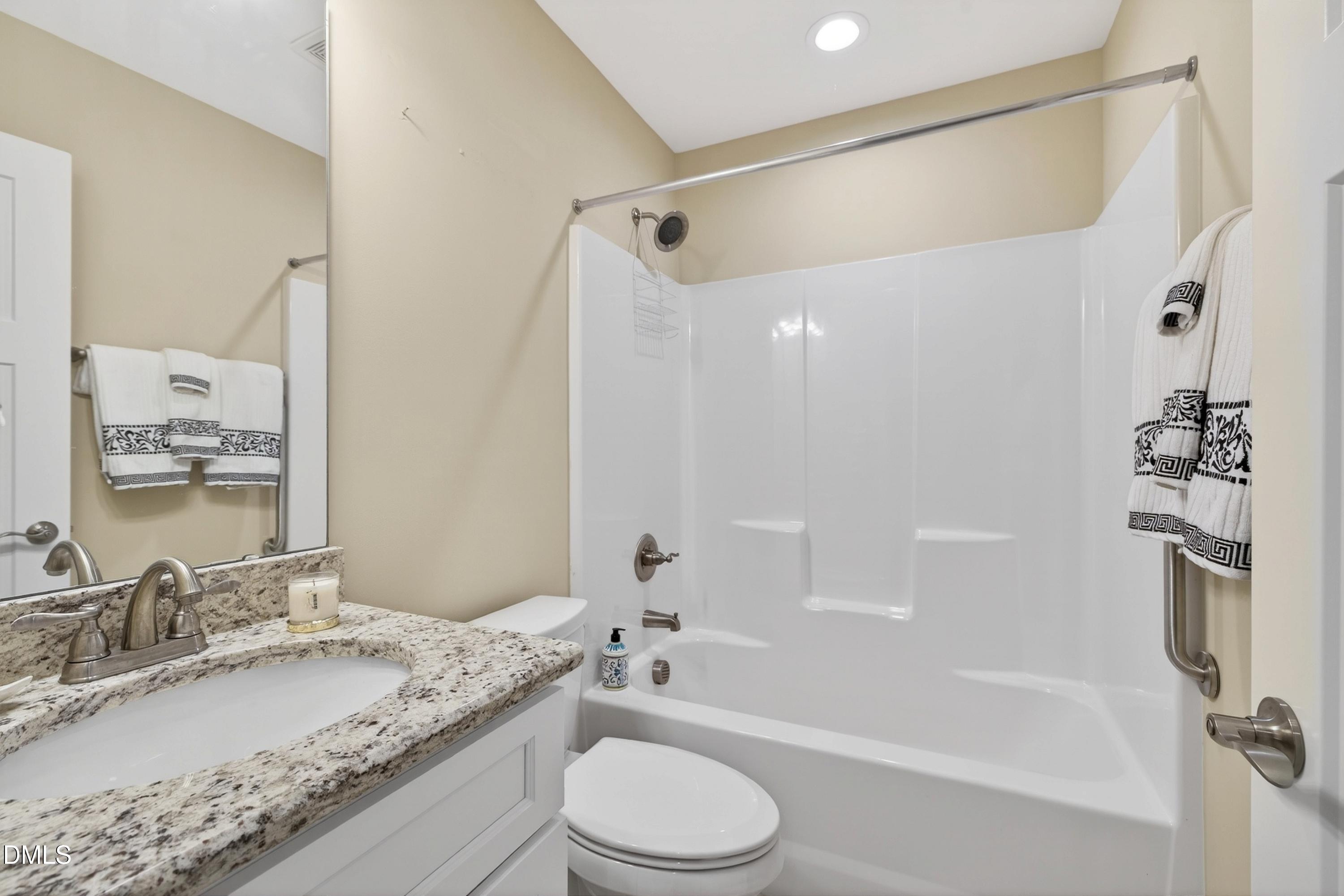 121 Telluride Trail Garner, NC 27529 - Photo 24 of 41 a bathroom with a granite countertop sink toilet and shower