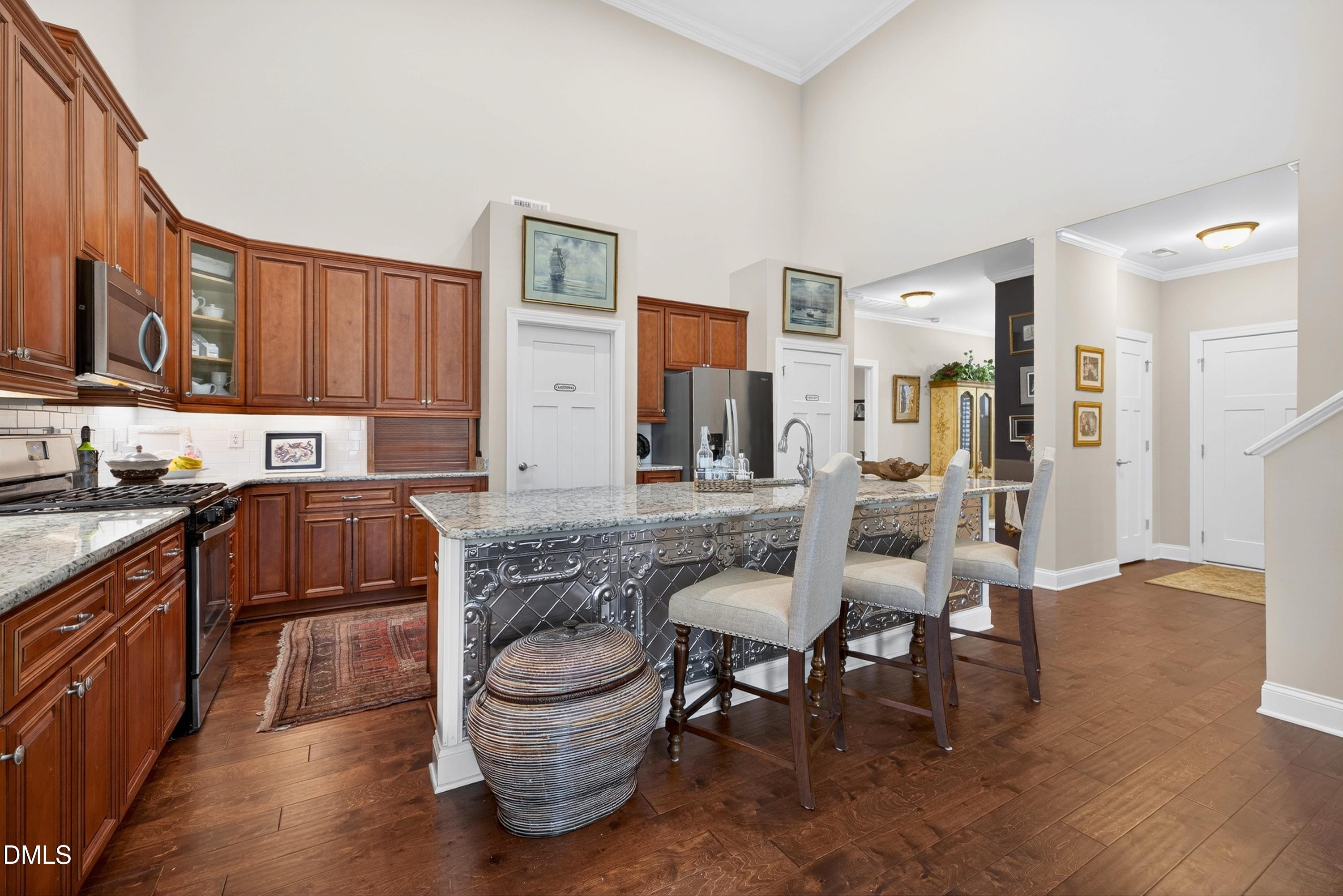 121 Telluride Trail Garner, NC 27529 - Photo 3 of 41 a kitchen with a table chairs and a refrigerator