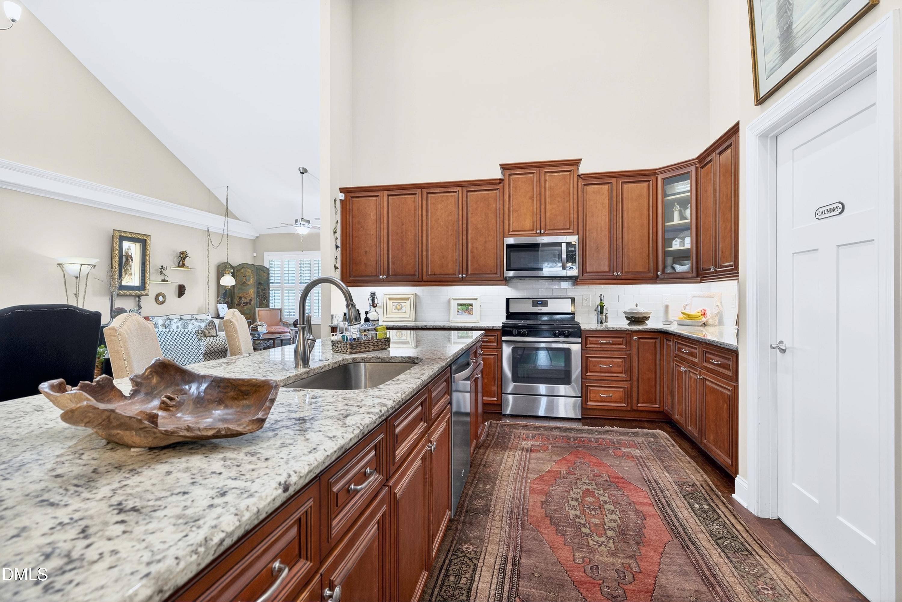 121 Telluride Trail Garner, NC 27529 - Photo 5 of 41 a kitchen with granite countertop a sink stove and cabinets