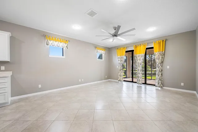 a view of a livingroom with furniture and a ceiling fan