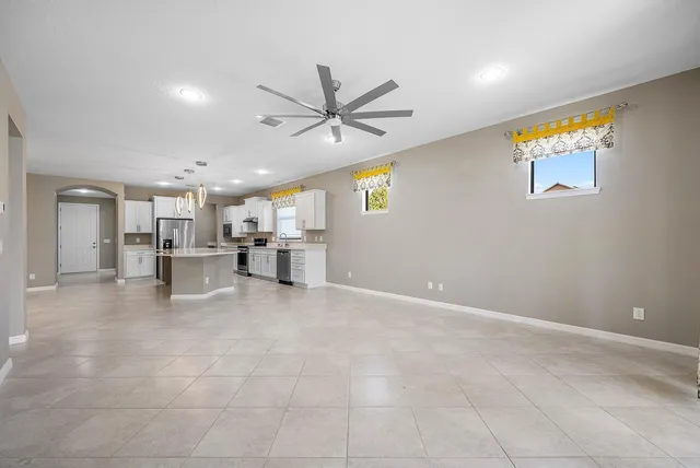 a view of a livingroom with a furniture chandelier fan and fire place