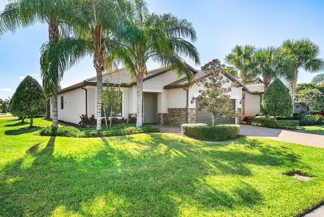 a view of a house with a swimming pool and a chairs