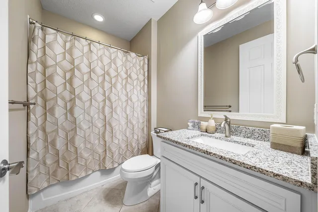 an empty room with closet and fan