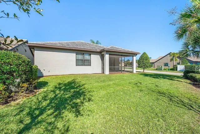 a view of a house with a backyard and a garage