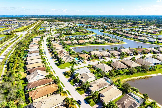 an aerial view of a swimming pool with outdoor seating and yard