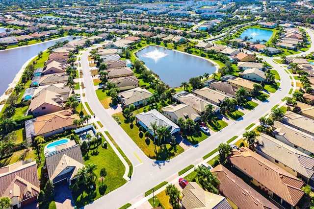 an aerial view of a swimming pool yard and mountain view in back