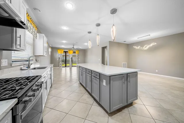 a kitchen with stainless steel appliances white cabinets and a sink