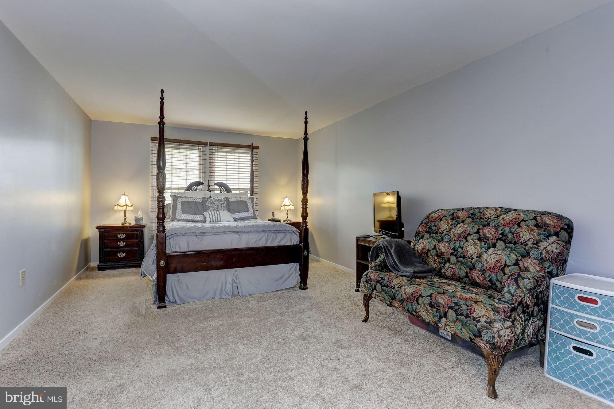 2302 Crossett Road Baltimore, MD 21237 - Photo 17 of 30 a bedroom with furniture and a lamp