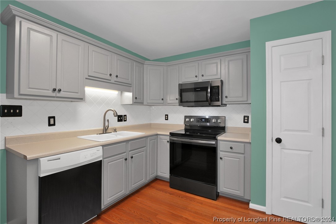 5808 Spreading Branch Road Hope Mills, NC 28348 - Photo 13 of 35 a kitchen with stainless steel appliances granite countertop a sink stove and refrigerator