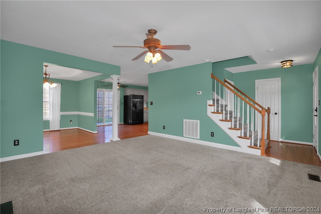 5808 Spreading Branch Road Hope Mills, NC 28348 - Photo 7 of 35 a view of a livingroom with a staircase and a ceiling fan