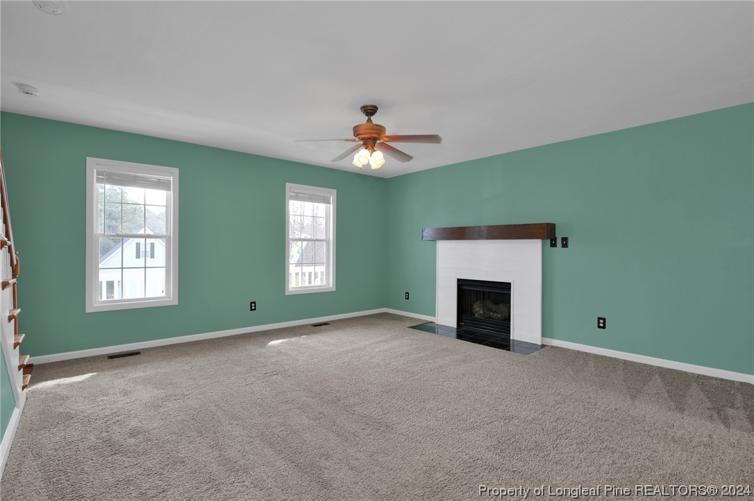 5808 Spreading Branch Road Hope Mills, NC 28348 - Photo 9 of 35 an empty room with fireplace and fan