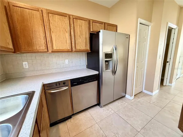 a kitchen with stainless steel appliances a refrigerator and cabinets