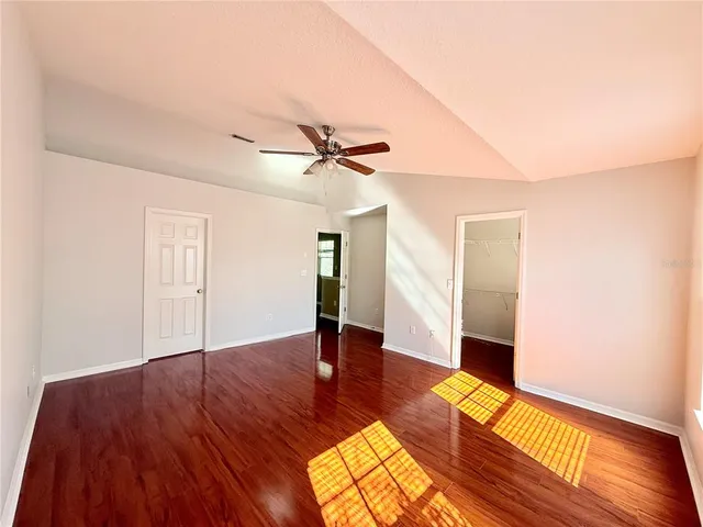 a view of empty room with wooden floor