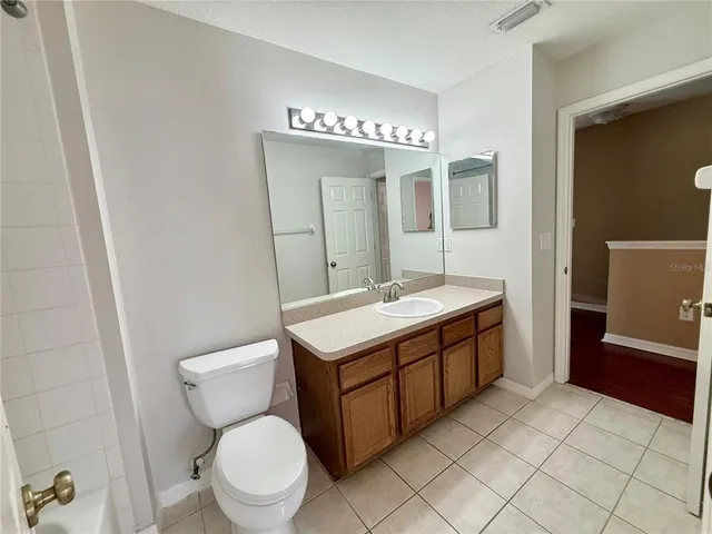 a bathroom with a sink toilet and mirror