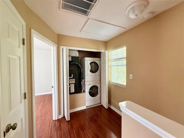 a view of a hardwood & utility room with a window