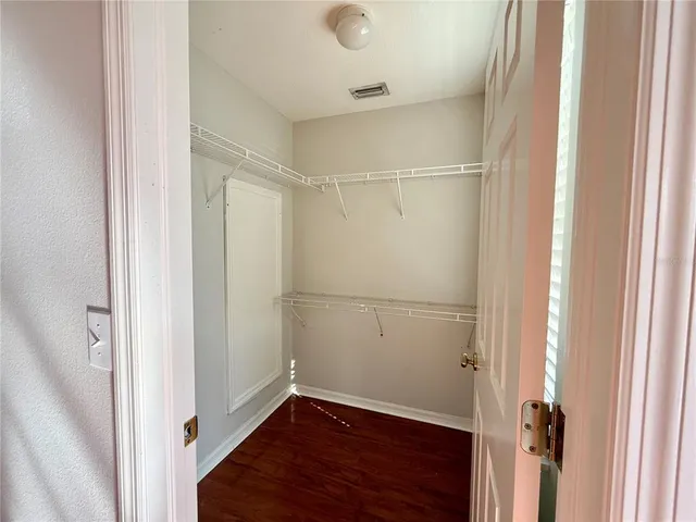 a view of a room with wooden floor