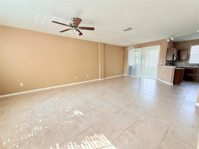 a view of a livingroom with a ceiling fan and window