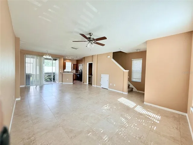 a view of a livingroom with a ceiling fan and wooden floor